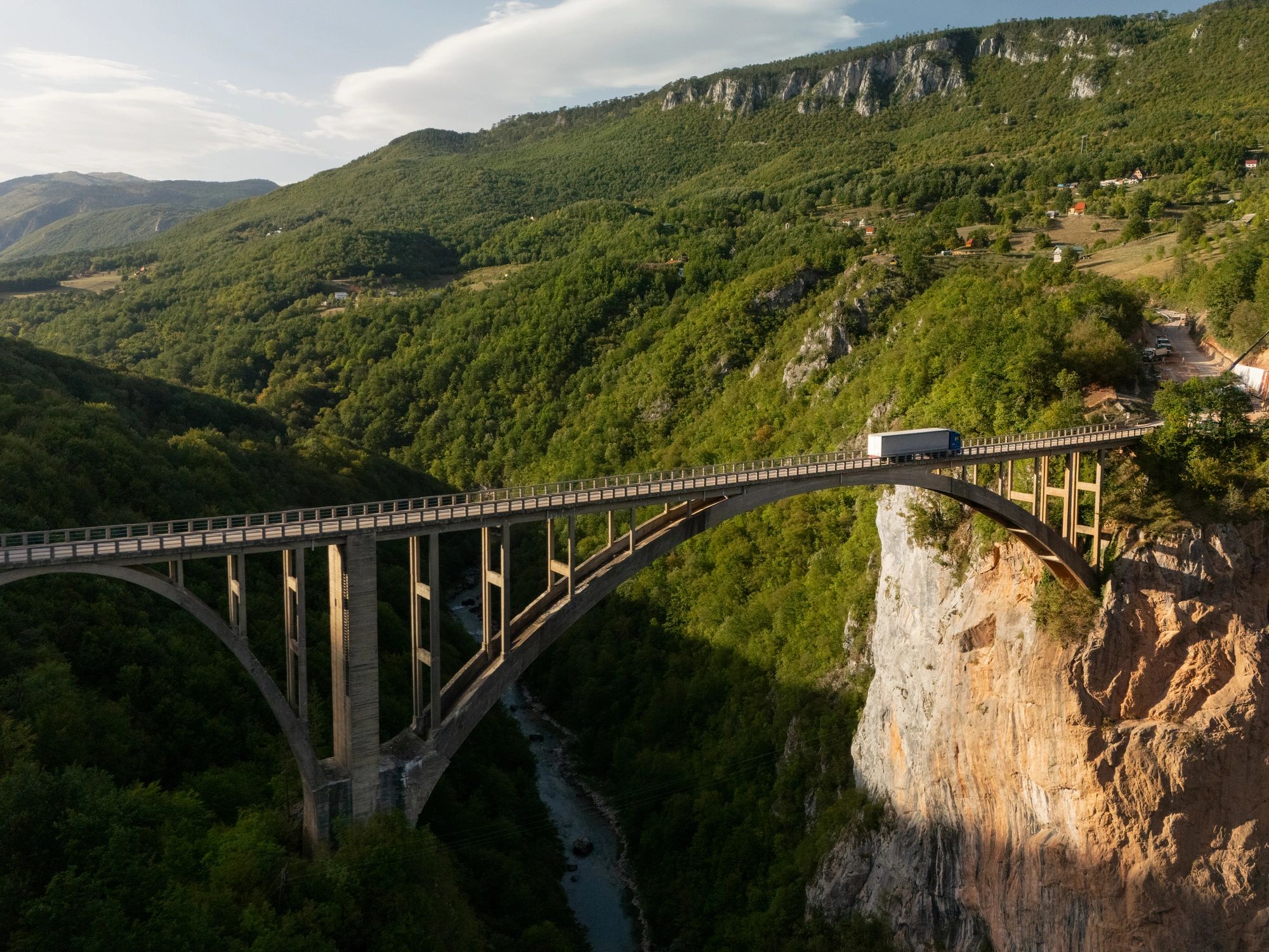 Bridge spanning a dramatic river canyon landscape